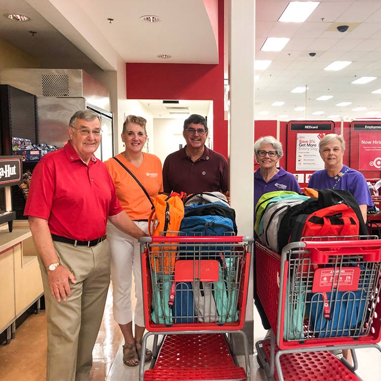 volunteers purchasing bookbags for back to school