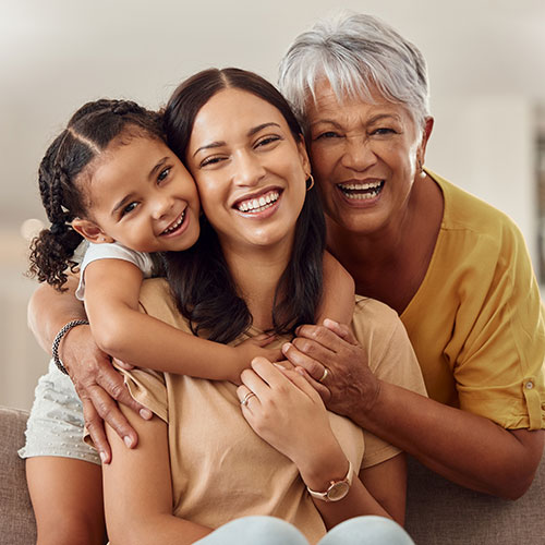 Three generations of women posing for the camera and smiling